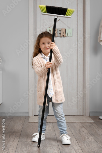 Cute little girl with broom...