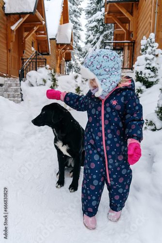 Little girl playing in a deep snow