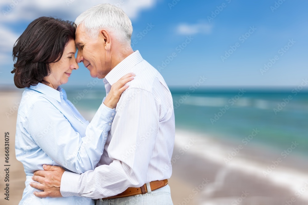 Obraz premium Senior happy couple have fun on the beach