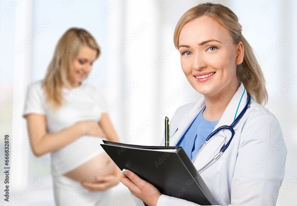 Happy young pregnant woman with doctor at clinic. Happy young pregnant woman with doctor at clinic.