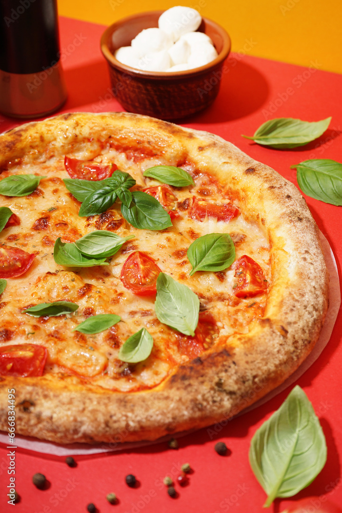 Tasty pizza Margarita with tomatoes and basil on red table
