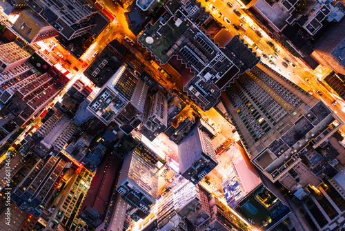 Aerial top view of downtown district buildings in night city light
