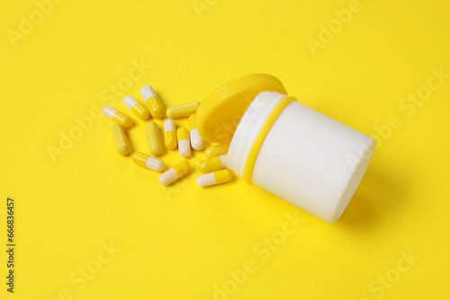 Jar with scattered pills on...