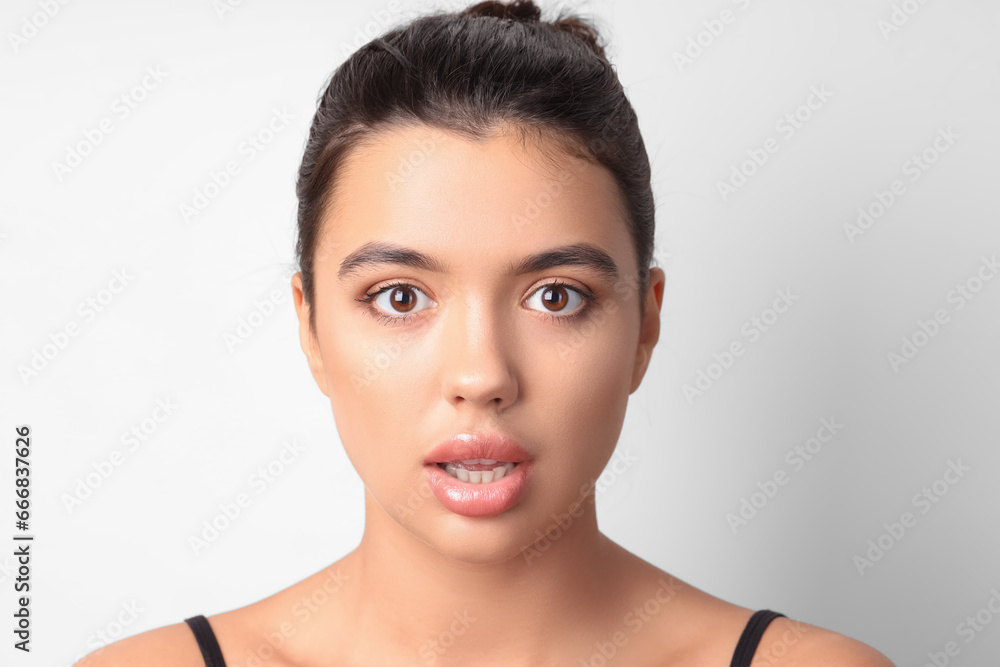 Surprised young woman with beautiful lips on light background, closeup Surprised young woman with beautiful lips on light background, closeup