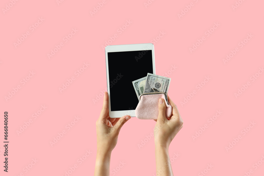 Woman with blank tablet computer and money on pink background Woman with blank tablet computer and money on pink background