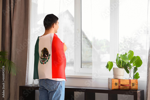 Young man with Mexican flag...