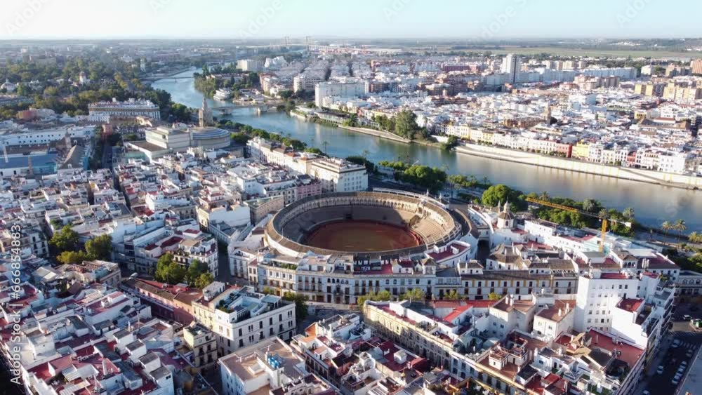 Seville Bullring, Maestranza Theater, And Torre del Oro By The Guadalquivir River In Seville, Spain. aerial pullback Seville Bullring, Maestranza Theater, And Torre del Oro By The Guadalquivir River In Seville, Spain. aerial pullback