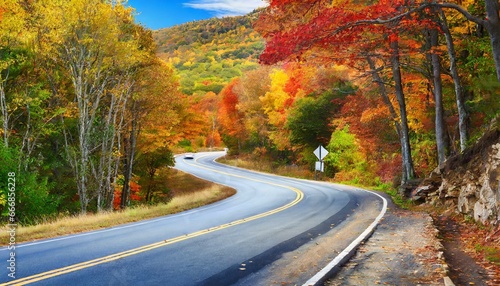 winding road curves through scenic autumn foliage trees in new england