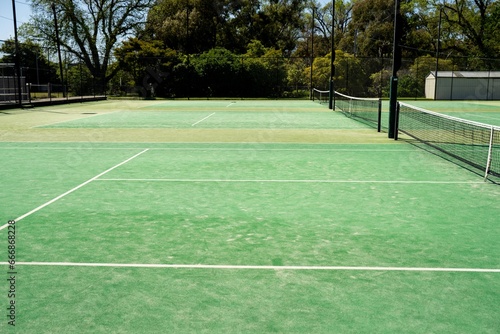 synthetic court in a park in summer, tennis court with a net © William