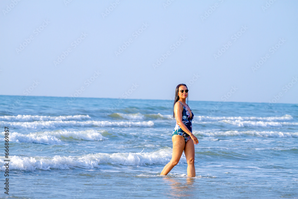 Woman body big with swimsuit relax at beach Woman body big with swimsuit relax at beach