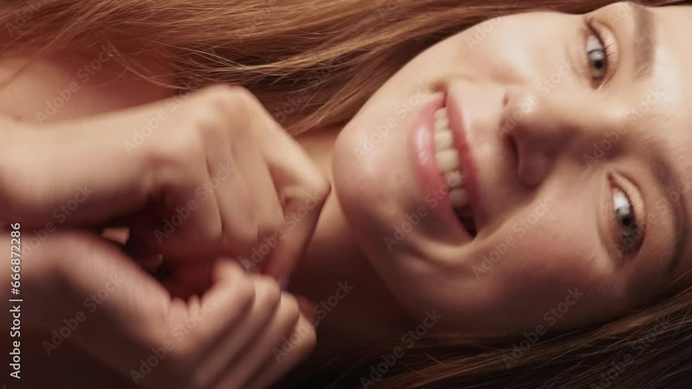 Vertical video. Skincare beauty. Natural face. Female wellness. Happy playful smiling woman with nude makeup radiant skin posing on beige background.