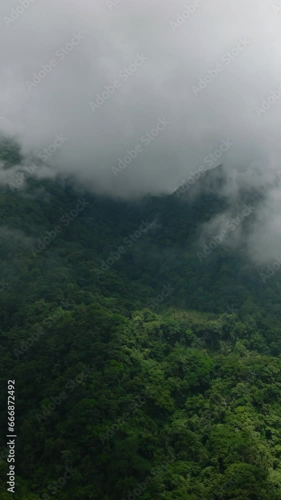 Scenic landscape with clouds over the mountain forest and jungle. Camiguin, Philippines. Vertical video. Scenic landscape with clouds over the mountain forest and jungle. Camiguin, Philippines. Vertical video.