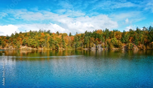 Pink Lake, Gatineau, Quebec, Canada during fall season with colorful tree photo