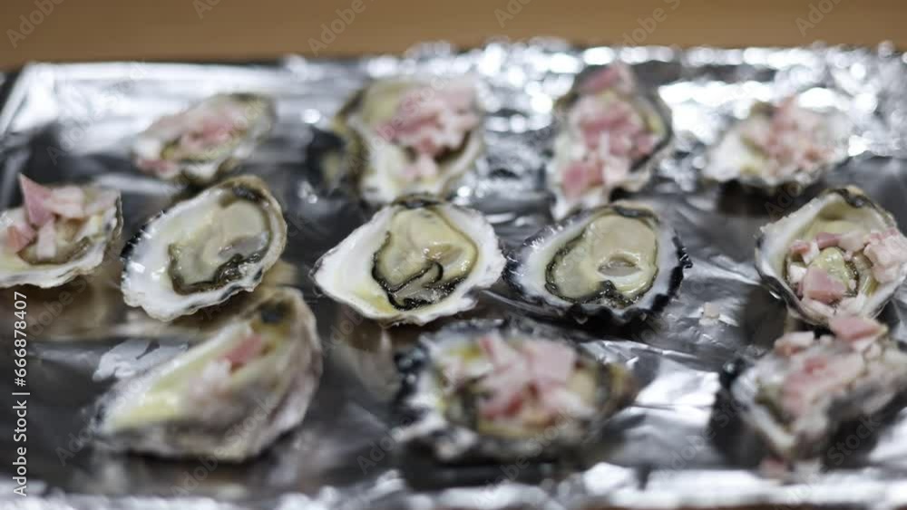 Oysters being cooked on tin foil for a delicious meal. Oysters being cooked on tin foil for a delicious meal.