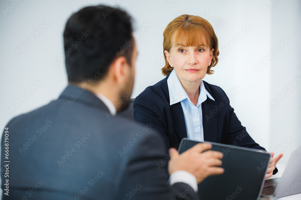 Business executive discussion with employee meeting in office. Two diverse professionals discussing project strategy and corporate plan of company Business executive discussion with employee meeting in office. Two diverse professionals discussing project strategy and corporate plan of company