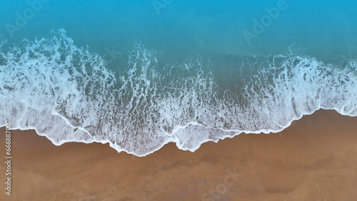 Beach Wave water in the Tropical summer beach with sandy beach background © SASITHORN