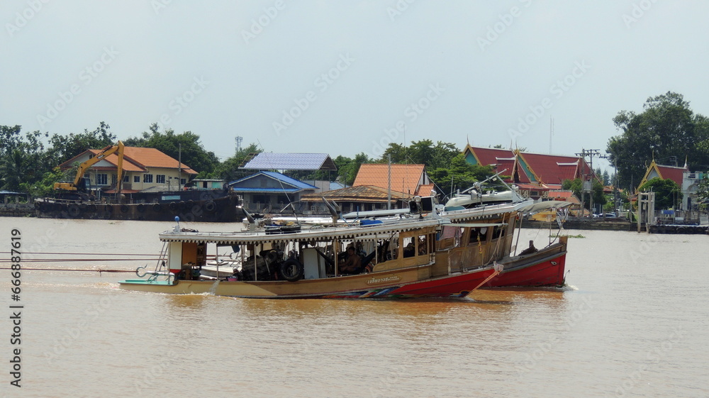 Tugboat, Pusher, Pusher Craft, Pusher Boat, Pusher Tug, or Towboat Pulling Huge Barge at Chao Phraya River, Thailand
