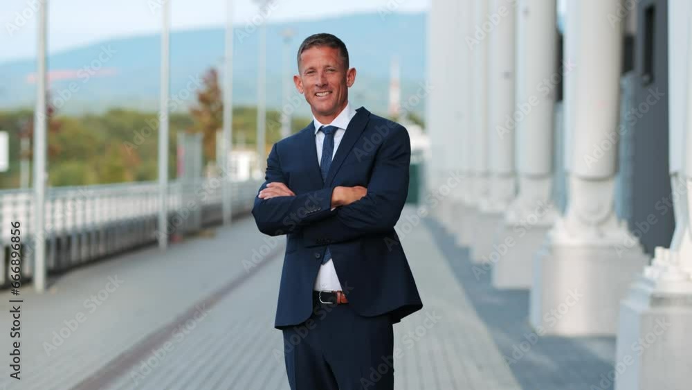 medium shot of a mature middle-aged businessman smiling at the camera medium shot of a mature middle-aged businessman smiling at the camera