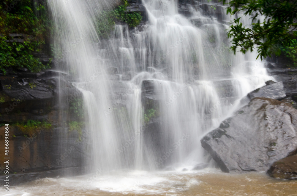 Beautiful lines of white water of waterfall on cliff Beautiful lines of white water of waterfall on cliff