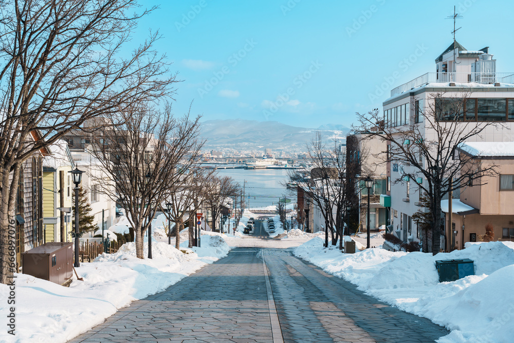 Fototapeta premium Hachiman Zaka Slope with Snow in winter season. landmark and popular for attractions in Hokkaido, Japan. Travel and Vacation concept