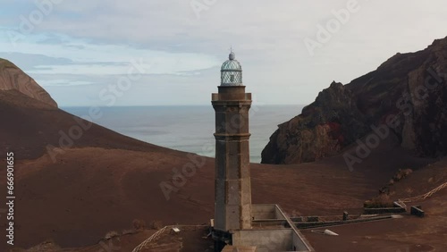 Aerial Drone shot of the capelinhos lighthouse, in the Faial island, Azores - Portugal. photo