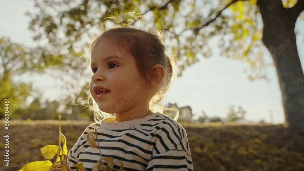 Little happy girl throwing up yellow autumn leaves. Daughter walking in forest. Autumn holiday in nature. Little happy girl throwing up yellow autumn leaves. Daughter walking in forest. Autumn holiday in nature.