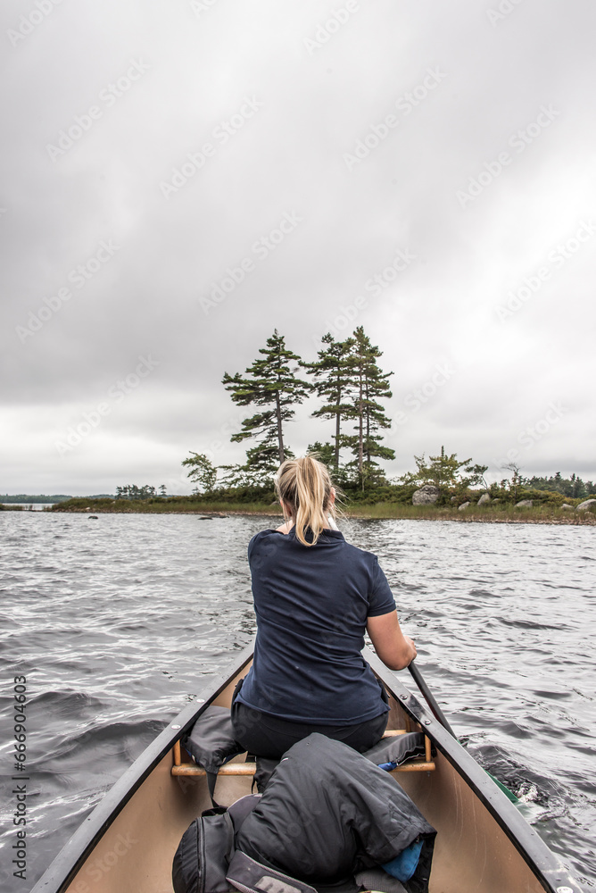 blonde Girl Canoe ride exploring nature on morning mist Kejimkujik National Park Wilderness Nova Scotia Canada blonde Girl Canoe ride exploring nature on morning mist Kejimkujik National Park Wilderness Nova Scotia Canada