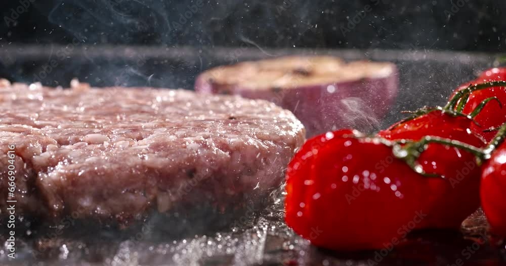 Pork cutlet for burger fried in frying pan with cherry tomatoes. Cinematic advertising burger cooking. Pan-fried delicious meat, ultimate junk food, fried cutlets diet. Aroma of cutlet frying in pan Pork cutlet for burger fried in frying pan with cherry tomatoes. Cinematic advertising burger cooking. Pan-fried delicious meat, ultimate junk food, fried cutlets diet. Aroma of cutlet frying in pan