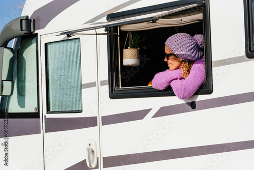 One happy wolo traveler woman enjoy view and have relax leisure activity alone looking outside the window of her camper van rv vehicle. Travel people lifestyle. Modern vanlife adult female people