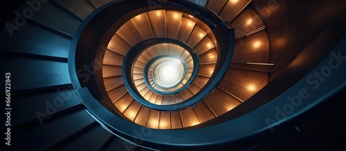 A top down view of a contemporary spiral staircase illuminated