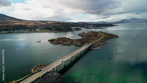 Drone descends above Skye bridge in Scotland as cars commute between island and mainland photo