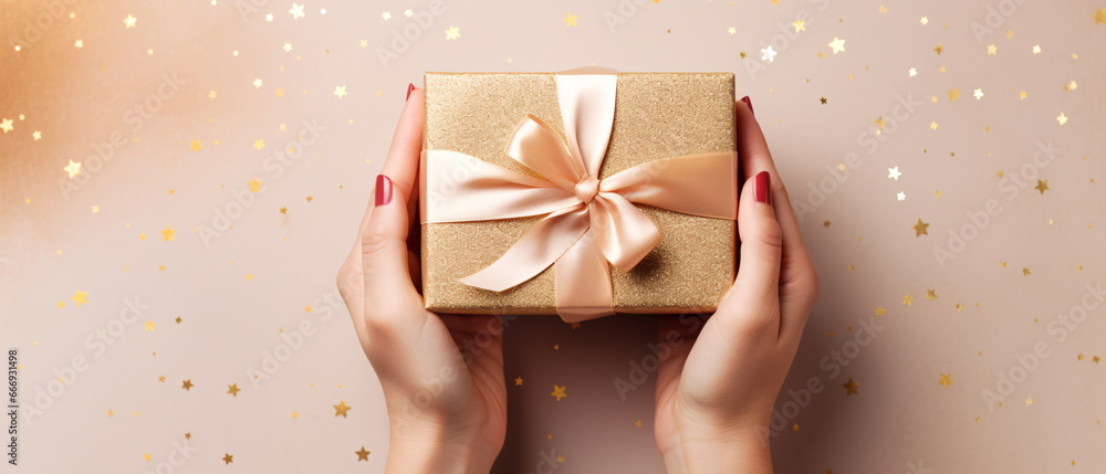 First person top view photo of female hands tying gold ribbon bow on craft paper Christmas gift box with copy space on pink background. Generative ai First person top view photo of female hands tying gold ribbon bow on craft paper Christmas gift box with copy space on pink background. Generative ai