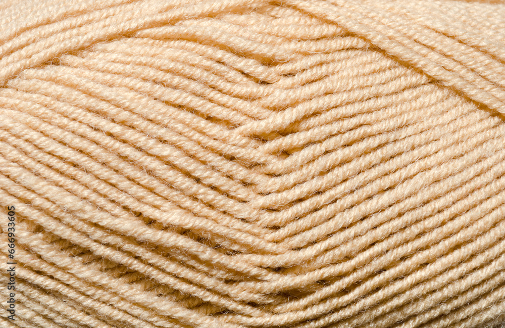 The texture of beige wool blend yarn. The texture of beige wool blend yarn.