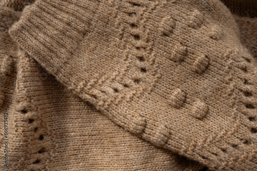 Stylized fashionable look. beige knitted sweater. Close-up knitting texture. Social media background. Soft, warm sweater