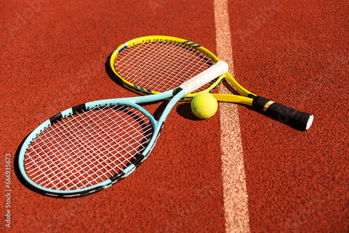 Close up view of tennis racket and balls on the clay tennis court © Angelov