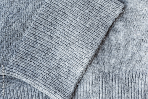 Stylized fashionable look. Gray knitted sweater. Close-up knitting texture. Social media background. Soft, warm sweater