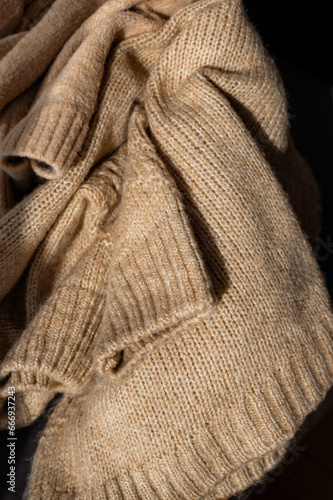 Stylized fashionable look. beige knitted sweater. Close-up knitting texture. Social media background. Soft, warm sweater