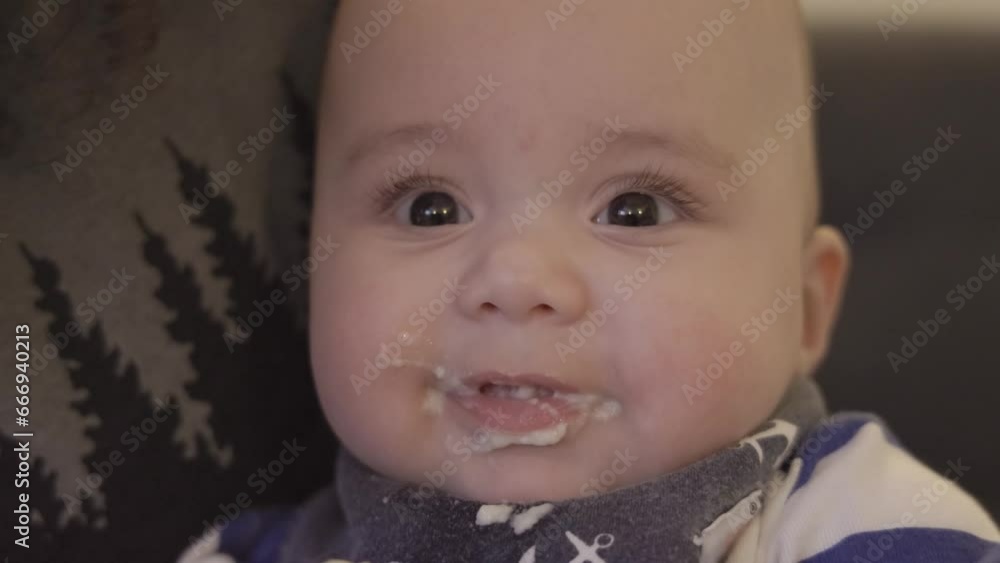 Baby Boy fed solid food with a spoon at home. Close up slow motion. Baby Boy fed solid food with a spoon at home. Close up slow motion.