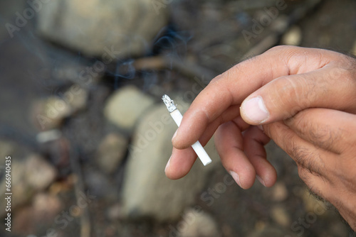 Caucasian man smoking a cigarette.