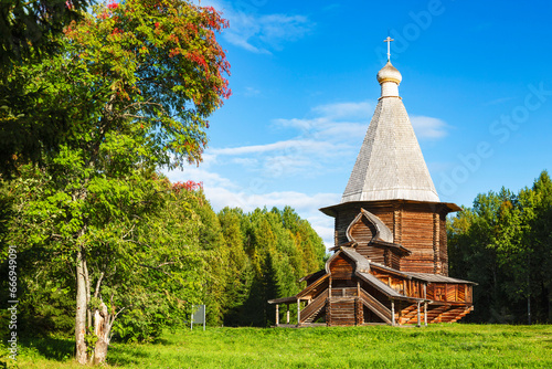 The ancient wooden St. George Church of the 17th century in the Malye Korely Museum of Wooden Architecture  on a sunny autumn day. Arkhangelsk region, Russia photo