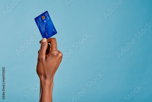 Konstfotografi Black female hand holding credit card isolated on blue background