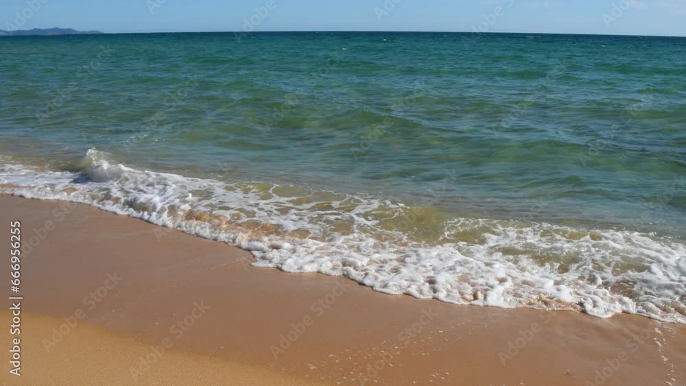 Ocean waves rush onto a sandy beach. Beautiful peaceful sea landscape. Ocean waves rush onto a sandy beach. Beautiful peaceful sea landscape.