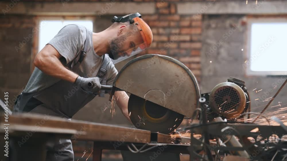 worker cuts metal on a circle and a circular saw. steel pipes and