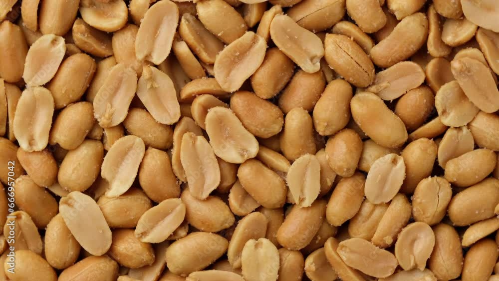 Zoom frame salted roasted peanuts top view, rotate