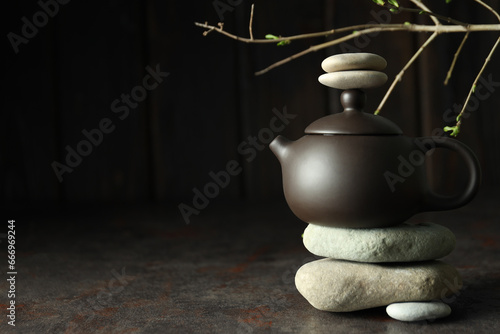 Asian tea concept, teapot on dark background.