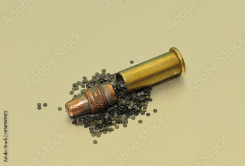 22 caliber bullet, brass casing and gun powder macro shot 