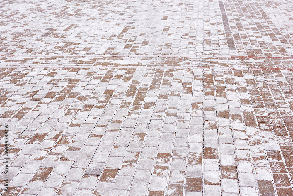 Salt stains on pedestrian paving slabs, salting sidewalk during winter