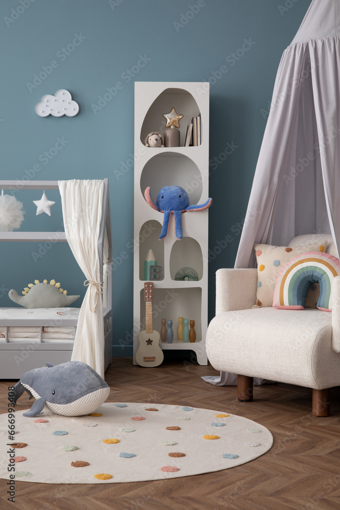 Interior design of cozy child room interior with bed, stylish rack, armchair, blue wall, round rug, colorful toys, guitar, books, ornament on wall and personal accessories. Home decor. Template. - obrazy, fototapety, plakaty 