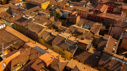Aerial view of the sloping roofs of the houses in the historic center of Sassuolo, Emilia Romagna, Italy. The orange color of traditional roofs predominates.