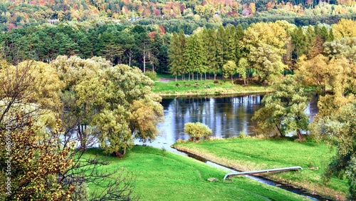 Fototapeta Naklejka Na Ścianę i Meble -  Beautiful autumn landscape with river and forest in Carpathian mountains, Sanok, Poland.